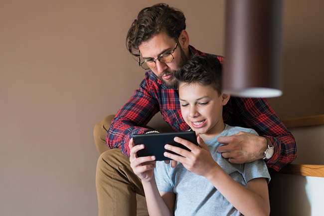 Father and son finding out more about their Foresters Plan