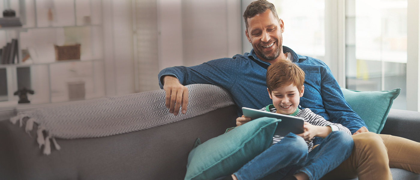 Happy father working out son's Junior ISA value using Foresters calculator