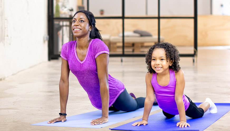 Mother and daughter doing yoga