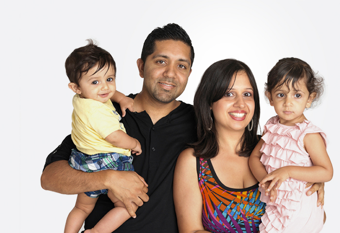 man and woman holding chidren