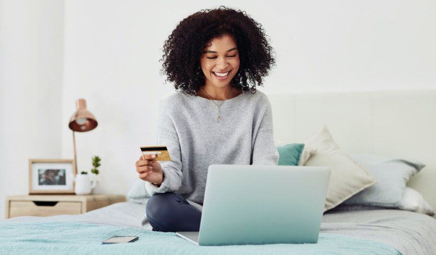 Woman looking at laptop in bed