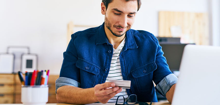 Man on laptop being cautious entering credit card details online